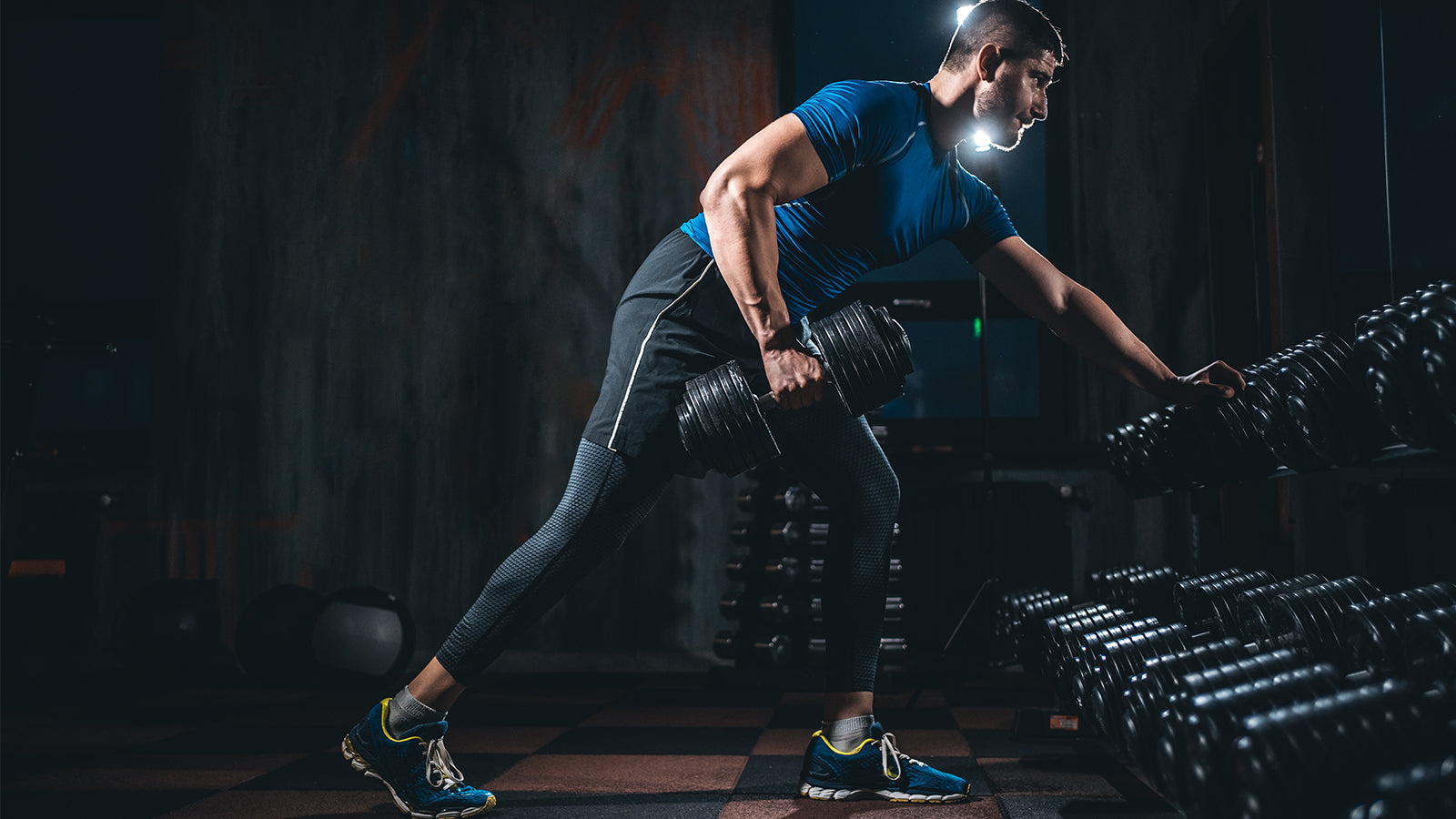 man doing triceps exercise at gym 
