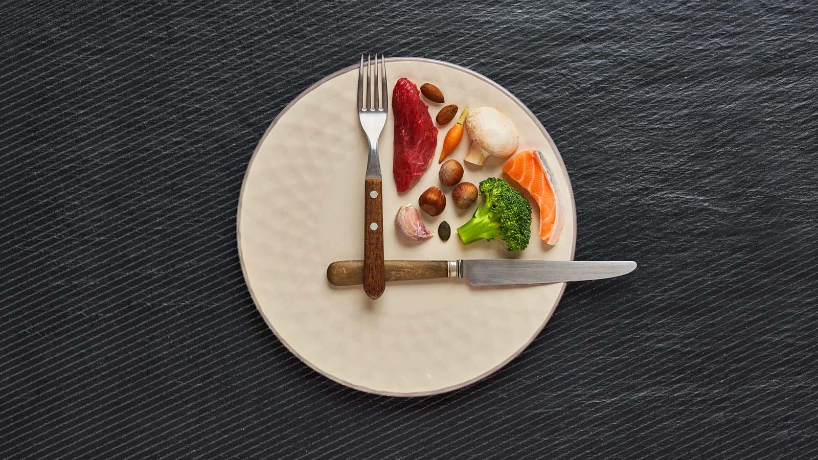 healthy food on a plate with fork and knife in clock position