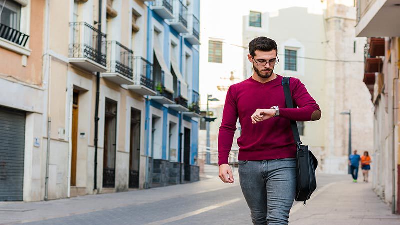 man on the go checking his watch
