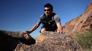 man hiking on rocks outside
