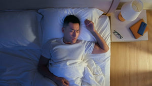 man in bed restless sleep
