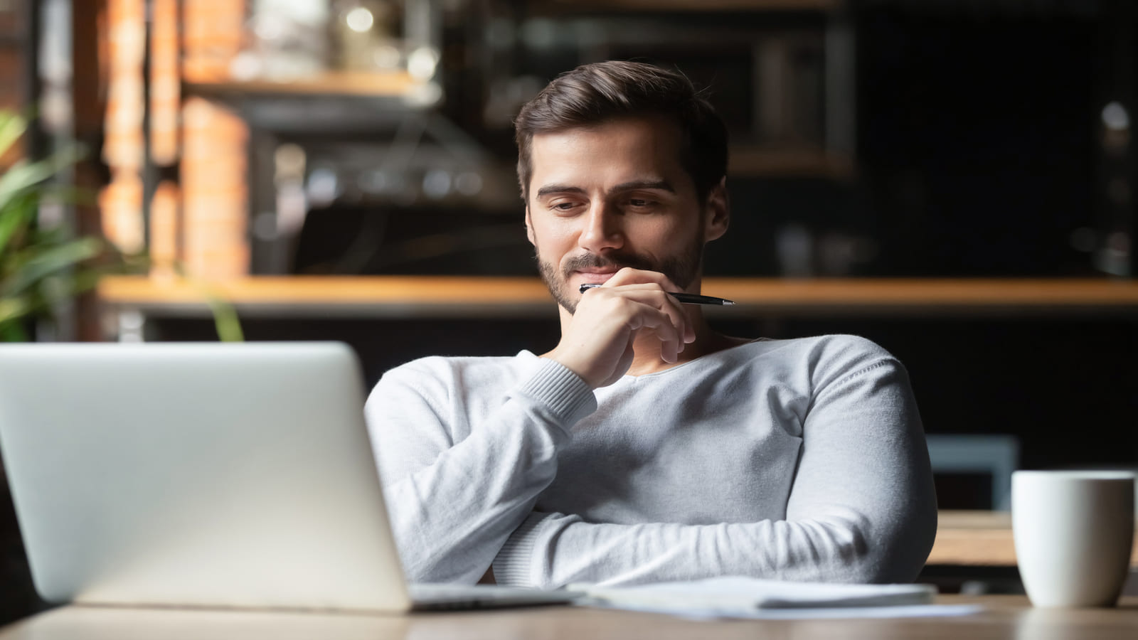 man thinking at computer