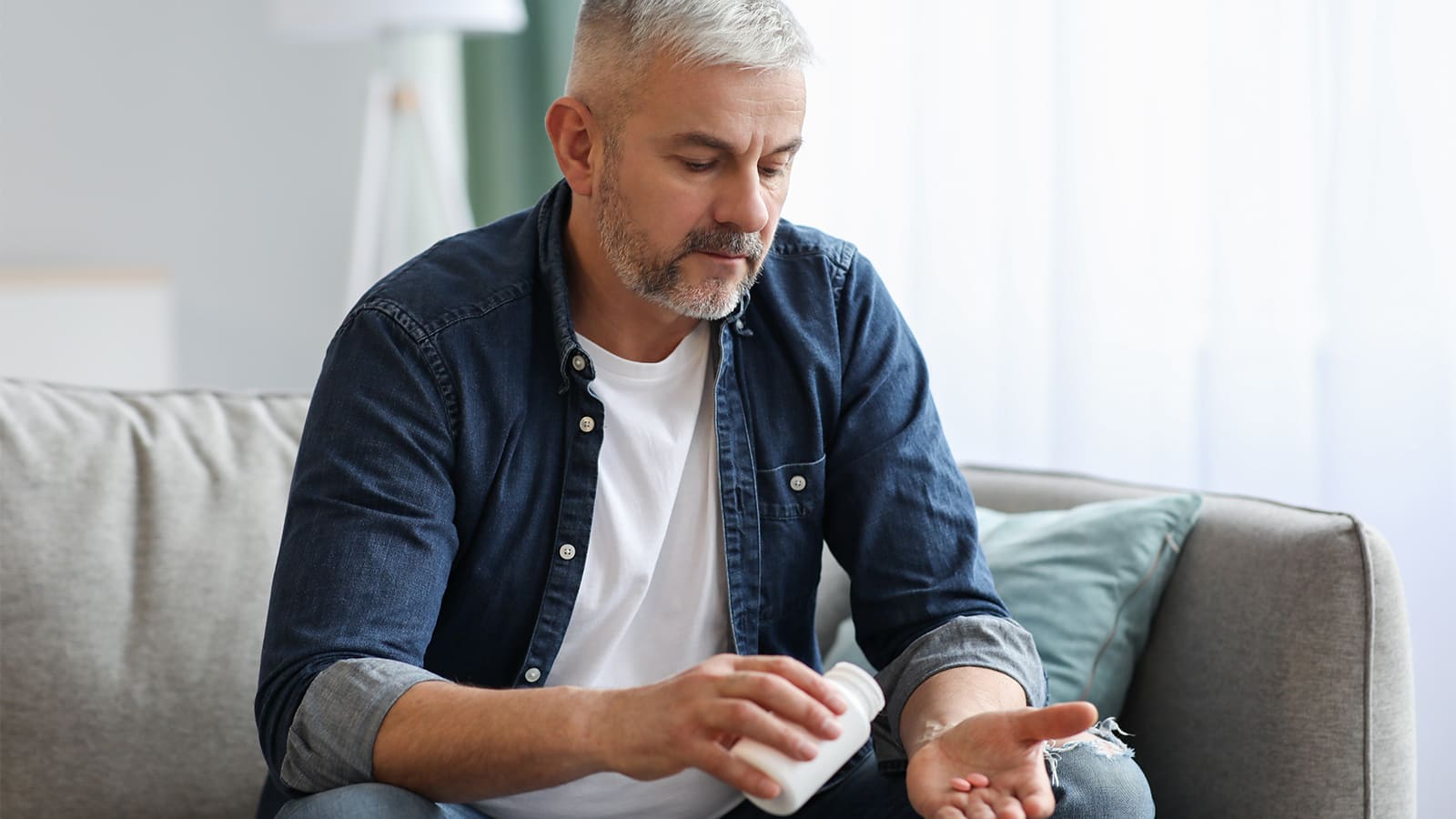 man taking peptide supplements