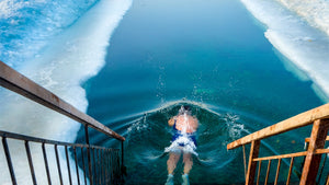 man swimming in cold water
