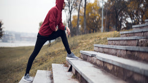 man stretching before running stairs