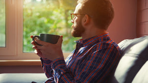 man drinking coffee in morning sunrise