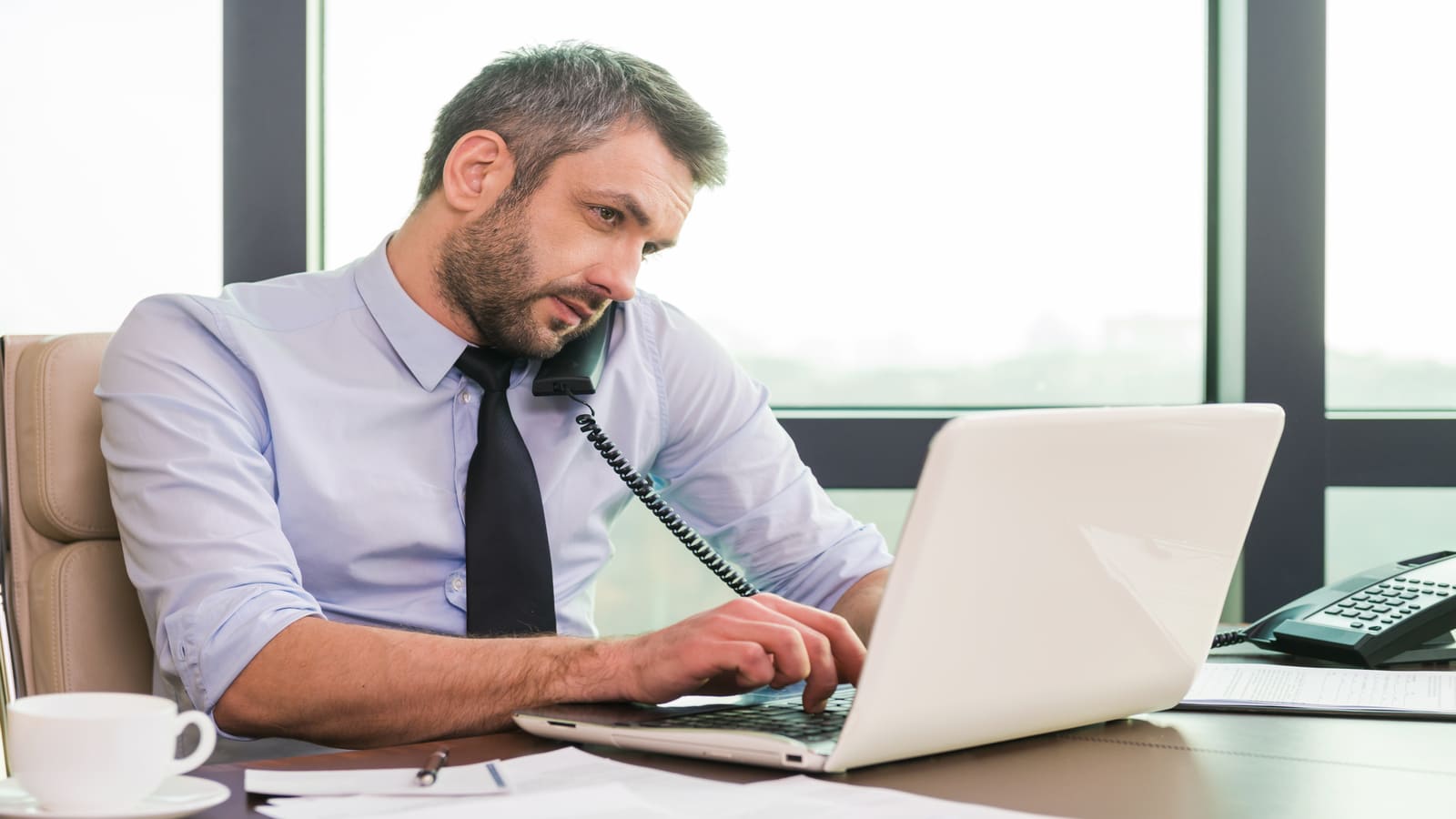 busy man working at laptop
