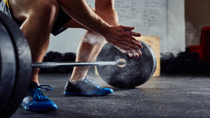 man getting ready to pick up a barbell