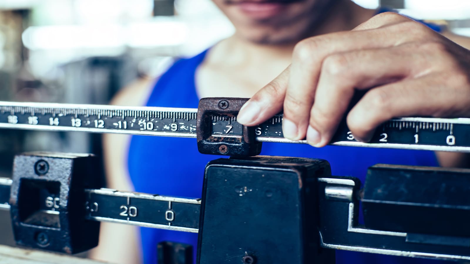 man weighing himself on a scale